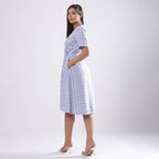 Left View of a Model wearing Powder Blue Handspun Plunge Neck Wrap Dress