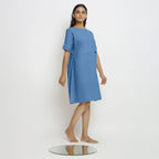 Right View of a Model wearing Powder Blue Handspun Vegetable Dyed Yoked Dress