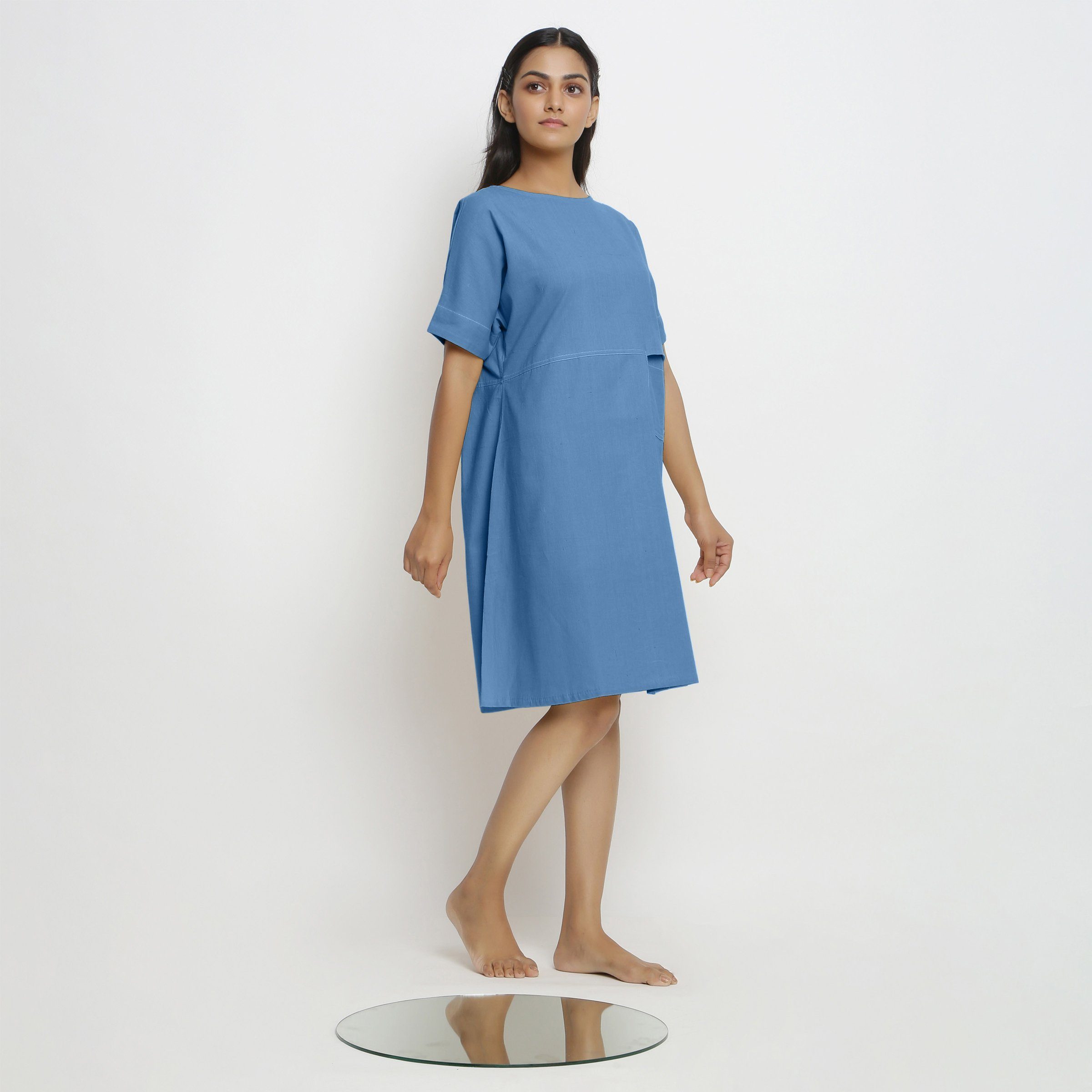 Right View of a Model wearing Powder Blue Handspun Vegetable Dyed Yoked Dress