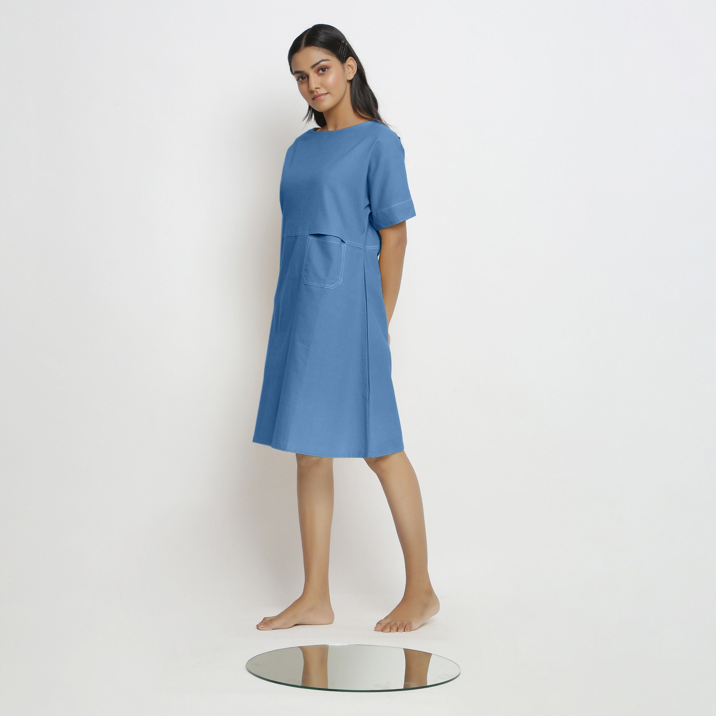 Left View of a Model wearing Powder Blue Handspun Vegetable Dyed Yoked Dress