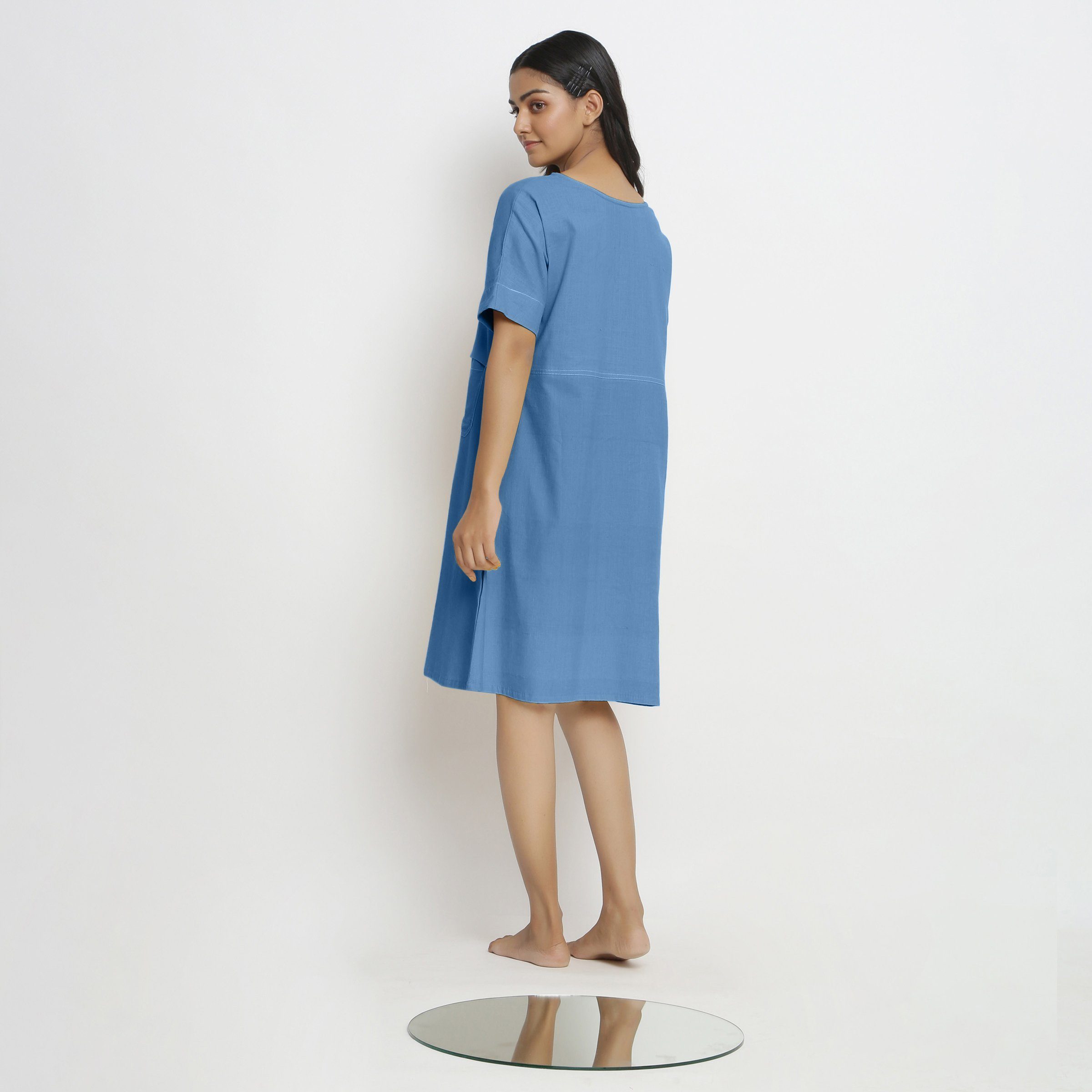 Back View of a Model wearing Powder Blue Handspun Vegetable Dyed Yoked Dress