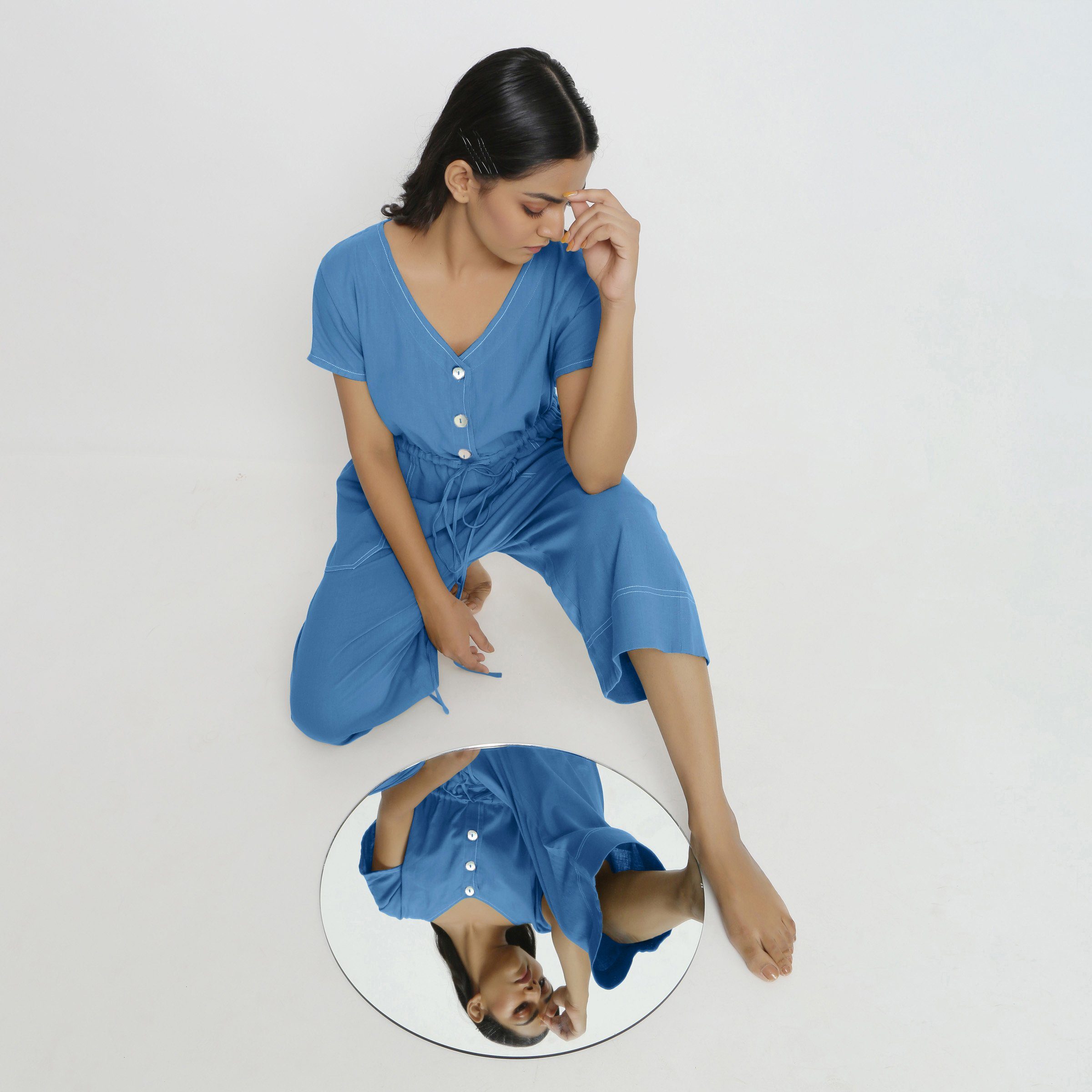 Front View of a Model wearing Powder Blue Vegetable Dyed Button-Down Jumpsuit