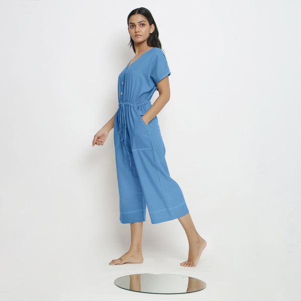 Left View of a Model wearing Powder Blue Vegetable Dyed Button-Down Jumpsuit