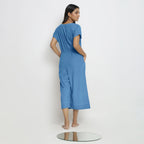 Back View of a Model wearing Powder Blue Vegetable Dyed Button-Down Jumpsuit