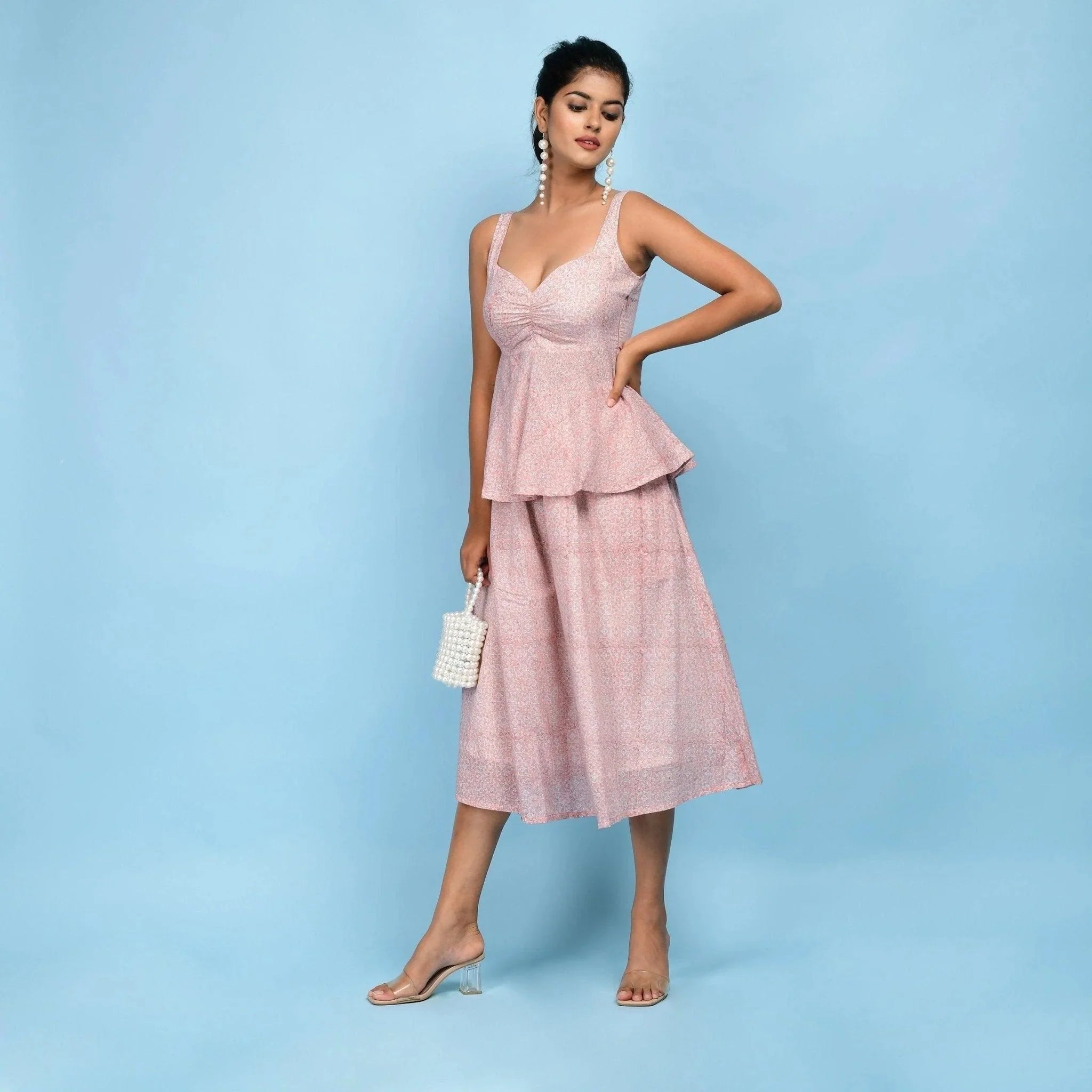 Left View of a Model wearing Powder Pink Block Printed Cotton Peplum Top