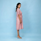 Right View of a Model wearing Powder Pink Cotton Block Print Knee-Length Kaftan Dress