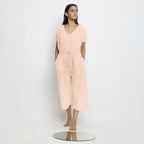 Front View of a Model wearing Powder Pink Vegetable Dyed Button-Down Jumpsuit