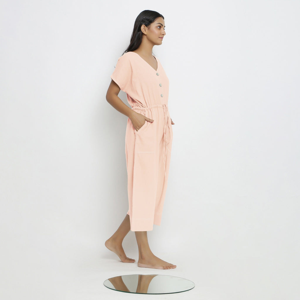 Right View of a Model wearing Powder Pink Vegetable Dyed Button-Down Jumpsuit