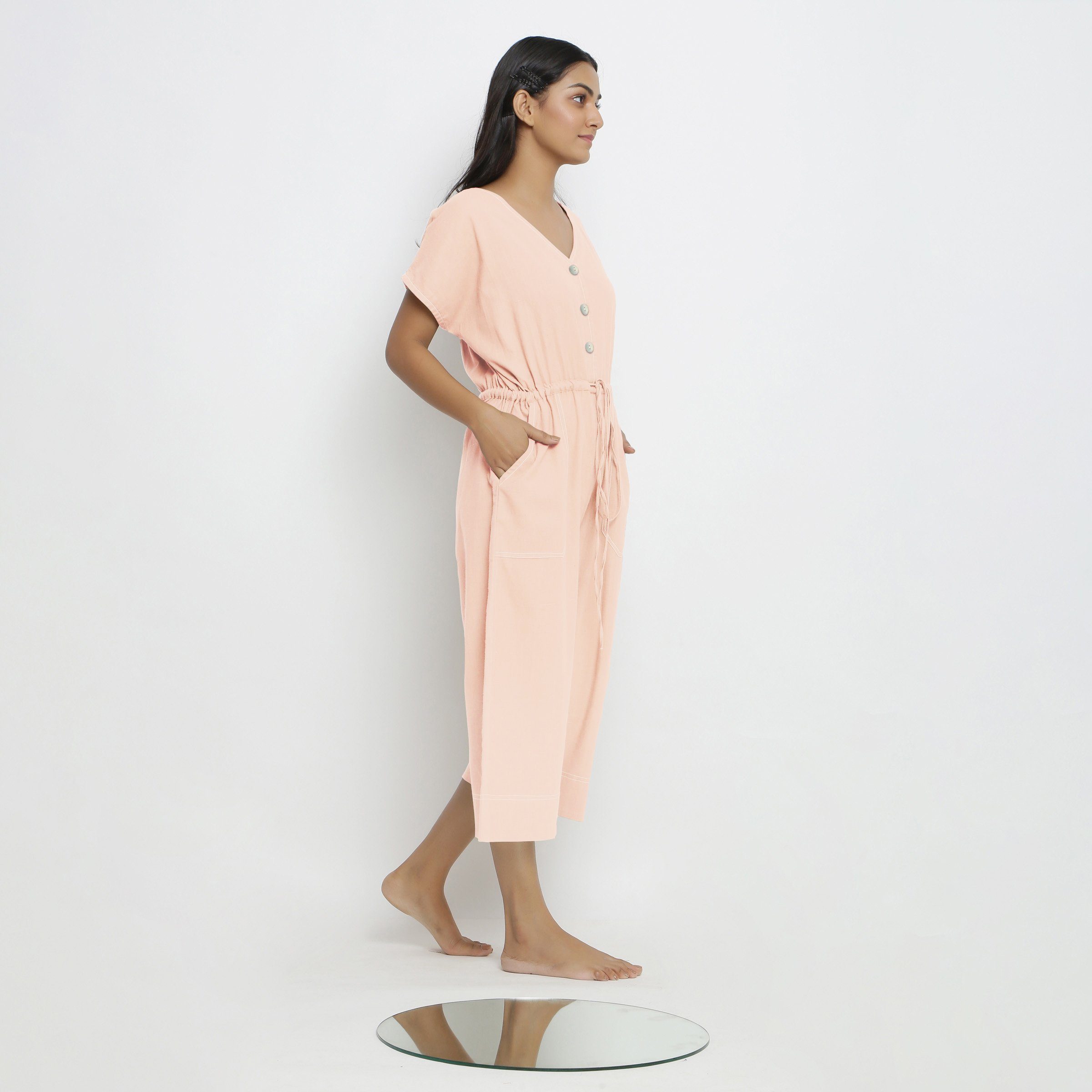 Right View of a Model wearing Powder Pink Vegetable Dyed Button-Down Jumpsuit