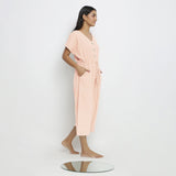 Right View of a Model wearing Powder Pink Vegetable Dyed Button-Down Jumpsuit
