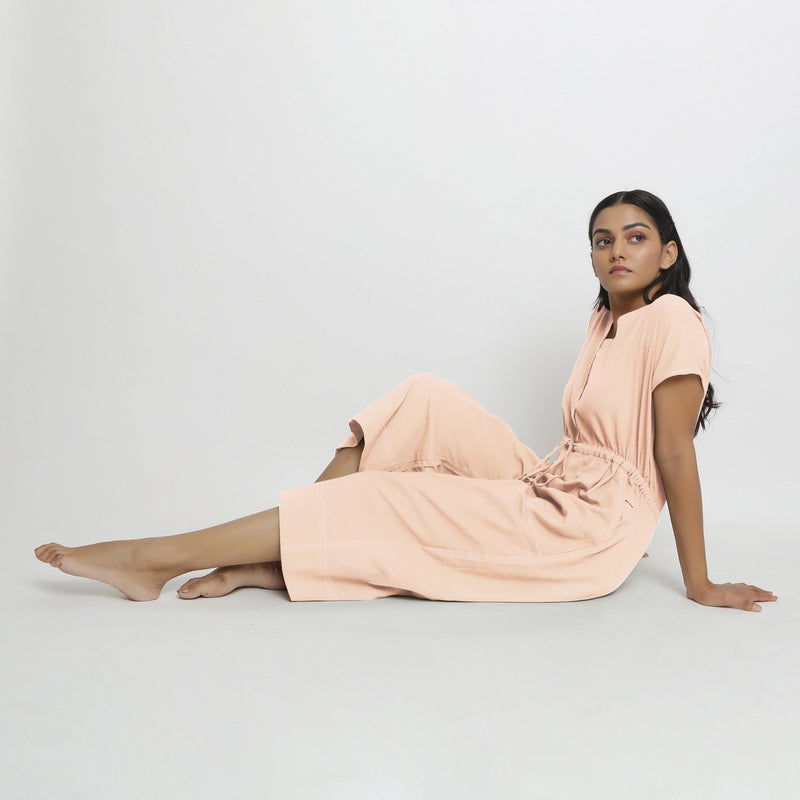 Left View of a Model wearing Powder Pink Vegetable Dyed Button-Down Jumpsuit