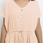 Front Detail of a Model wearing Powder Pink Vegetable Dyed Button-Down Jumpsuit