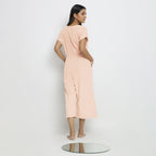 Back View of a Model wearing Powder Pink Vegetable Dyed Button-Down Jumpsuit