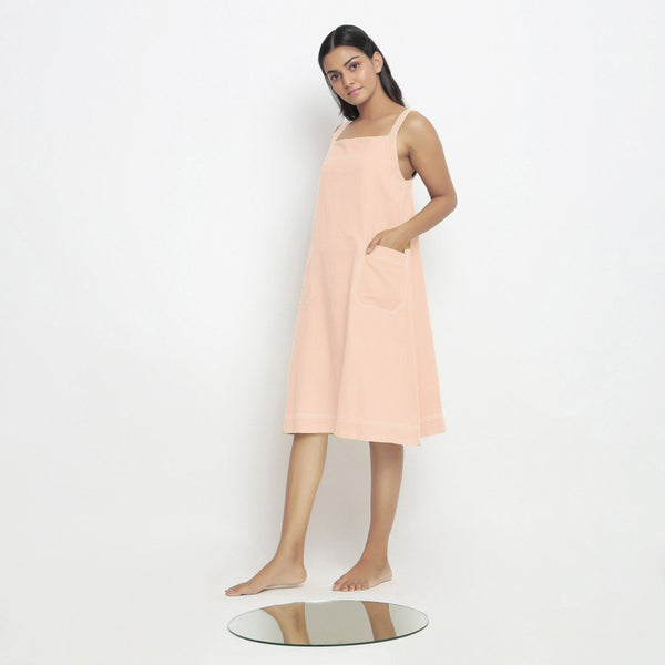 Left View of a Model wearing Powder Pink Vegetable Dyed Handspun Slip Dress