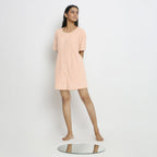 Front View of a Model wearing Powder Pink Vegetable Dyed Romper