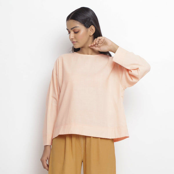 Front View of a Model wearing Powder Pink Vegetable Dyed Cotton Loose Fit Tie Neck Top