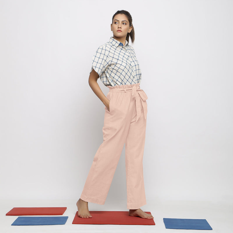 Right View of a Model wearing Powder Pink Vegetable Dyed Wide Legged Paperbag Pant