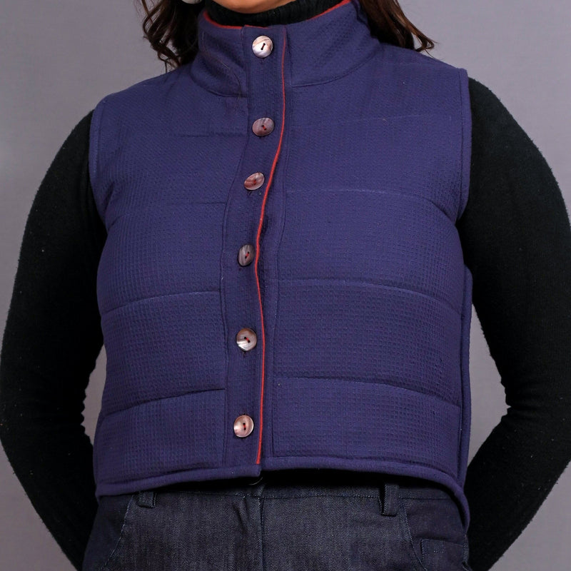 Front Detail of a Model wearing Reversible Blue and Red Warm Cotton Waffle Sleeveless Quilted Puffer Jacket
