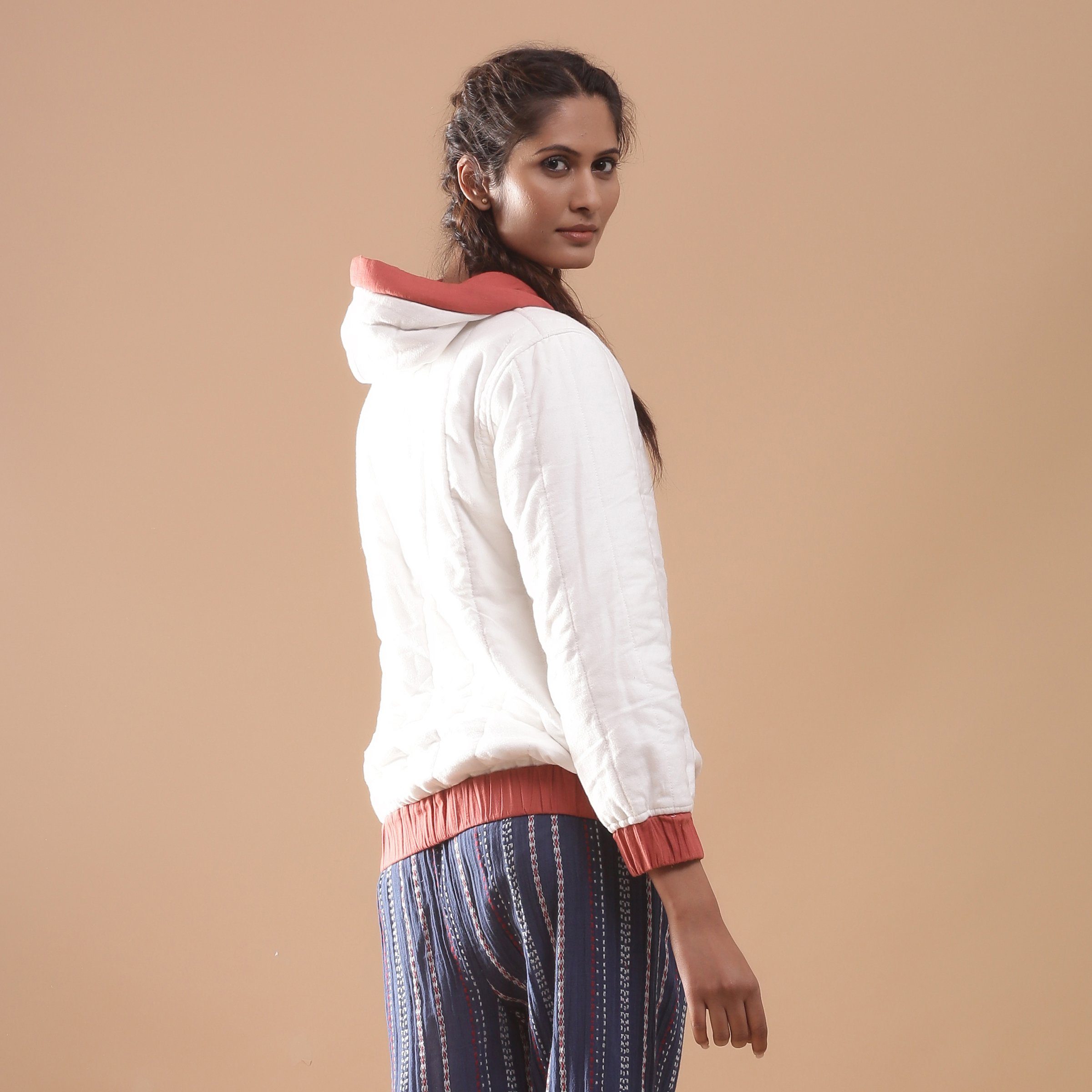 Back View of a Model wearing Reversible Warm Cotton Quilted Bomber Hoodie Jacket