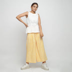 Front View of a Model wearing Ruffled Off-White Cotton Peplum Top