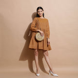 Front View of a Model wearing Rust Handspun Solid Gathered Dress