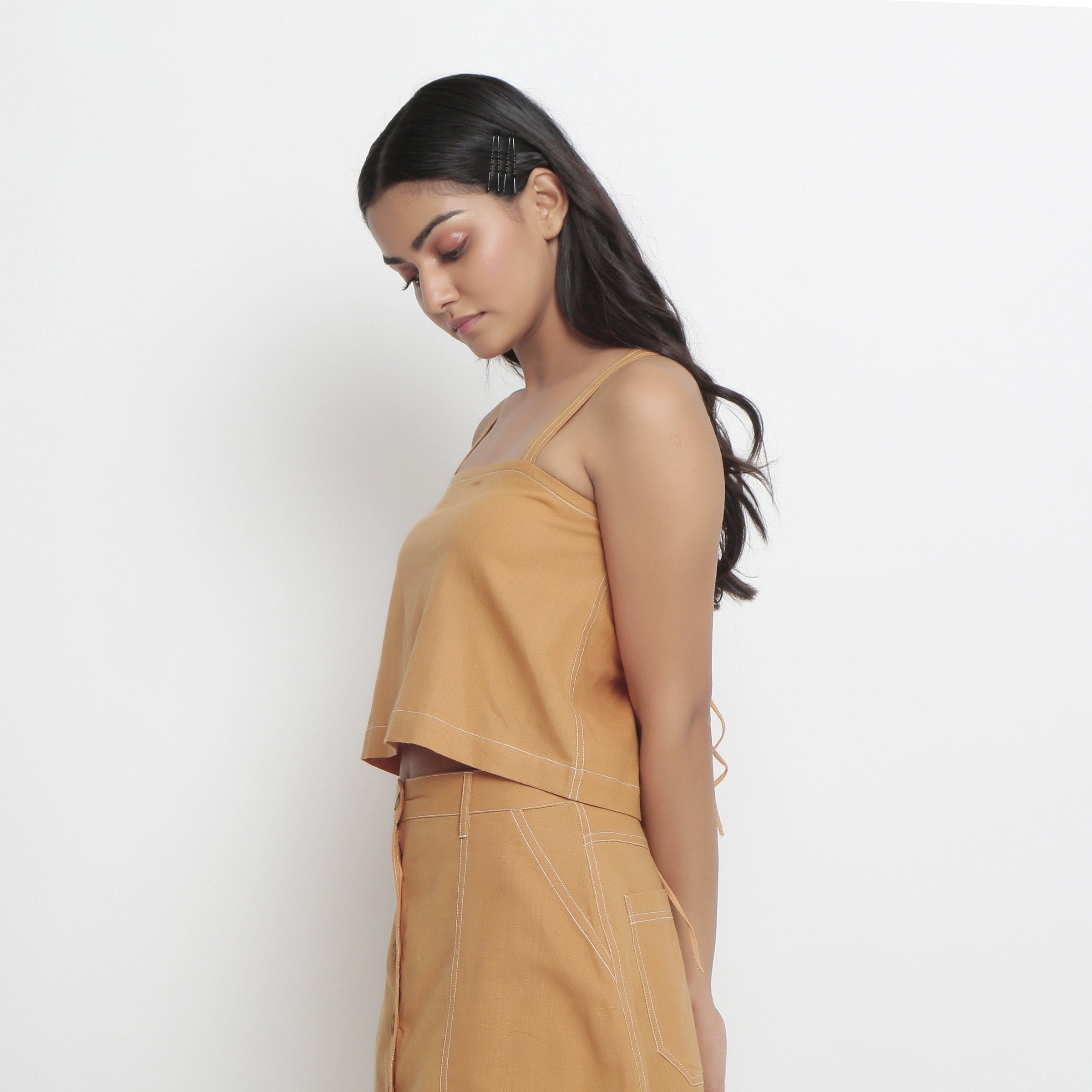 Left View of a Model wearing Rust Handspun Cotton Spaghetti Top