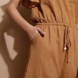 Close View of a Model wearing Rust Handspun Solid Cotton Playsuit