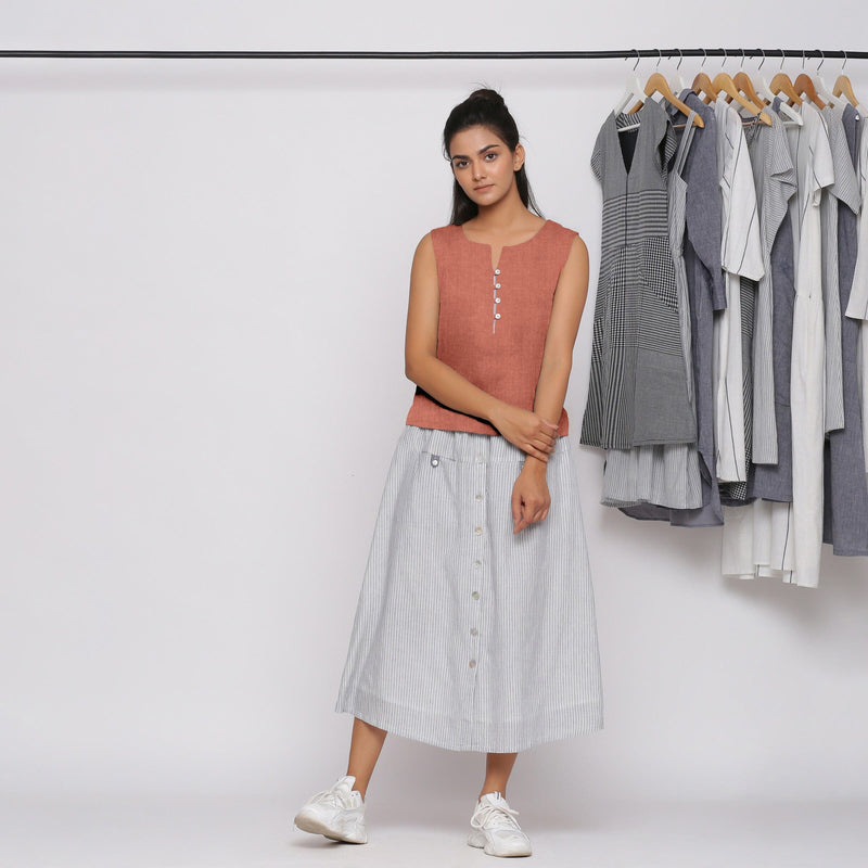 Front View of a Model wearing Rust Sandstone Linen Split Neck Button-Down Sleeveless Top