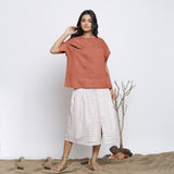 Front View of a Model wearing Rust Sandstone Round Neck Linen Gathered Top