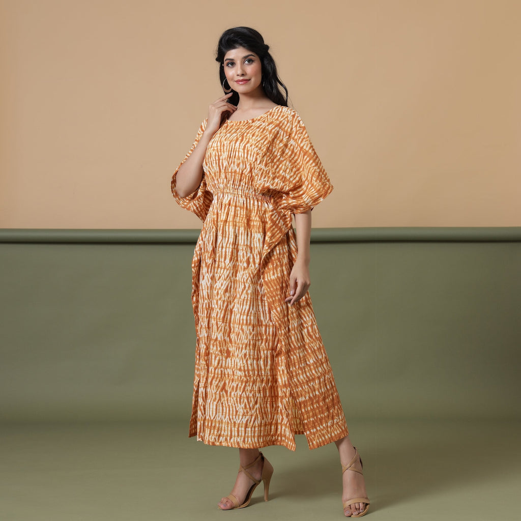 Left View of a Model wearing Rust Sandstone Shibori Tie-Dye Cotton Midi Kaftan Dress