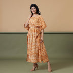 Left View of a Model wearing Rust Sandstone Shibori Tie-Dye Cotton Midi Kaftan Dress