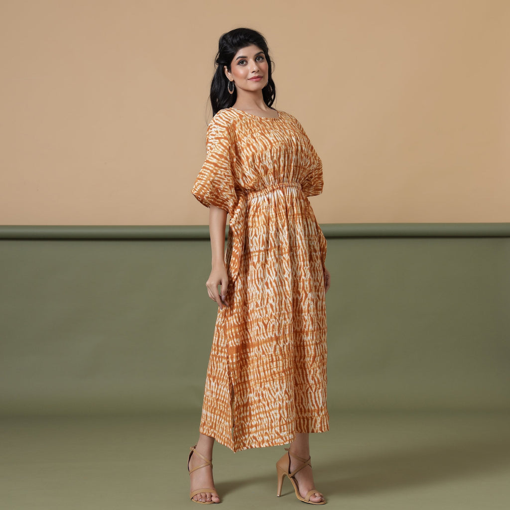 Right View of a Model wearing Rust Sandstone Shibori Tie-Dye Cotton Midi Kaftan Dress