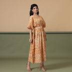 Right View of a Model wearing Rust Sandstone Shibori Tie-Dye Cotton Midi Kaftan Dress
