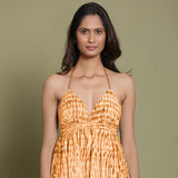 Front View of a Model wearing Rust Shibori Halter Neck Gathered Dress