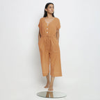 Front View of a Model wearing Rust Vegetable Dyed Button-Down Jumpsuit