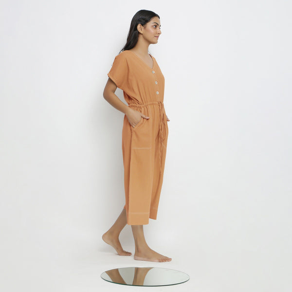 Right View of a Model wearing Rust Vegetable Dyed Button-Down Jumpsuit