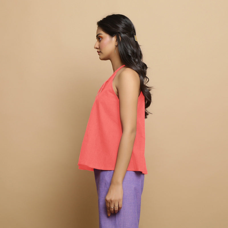 Left View of a Model wearing Salmon Pink Hand-Embroidered Halter Neck Top