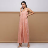 Left View of Model wearing Salmon Pink Handspun Pleated Jumpsuit