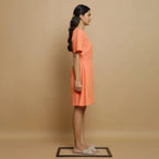 Right View of a Model wearing Salmon Pink Button-Down Godet Jumpsuit