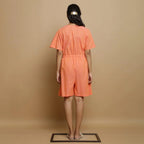 Back View of a Model wearing Salmon Pink Button-Down Godet Jumpsuit
