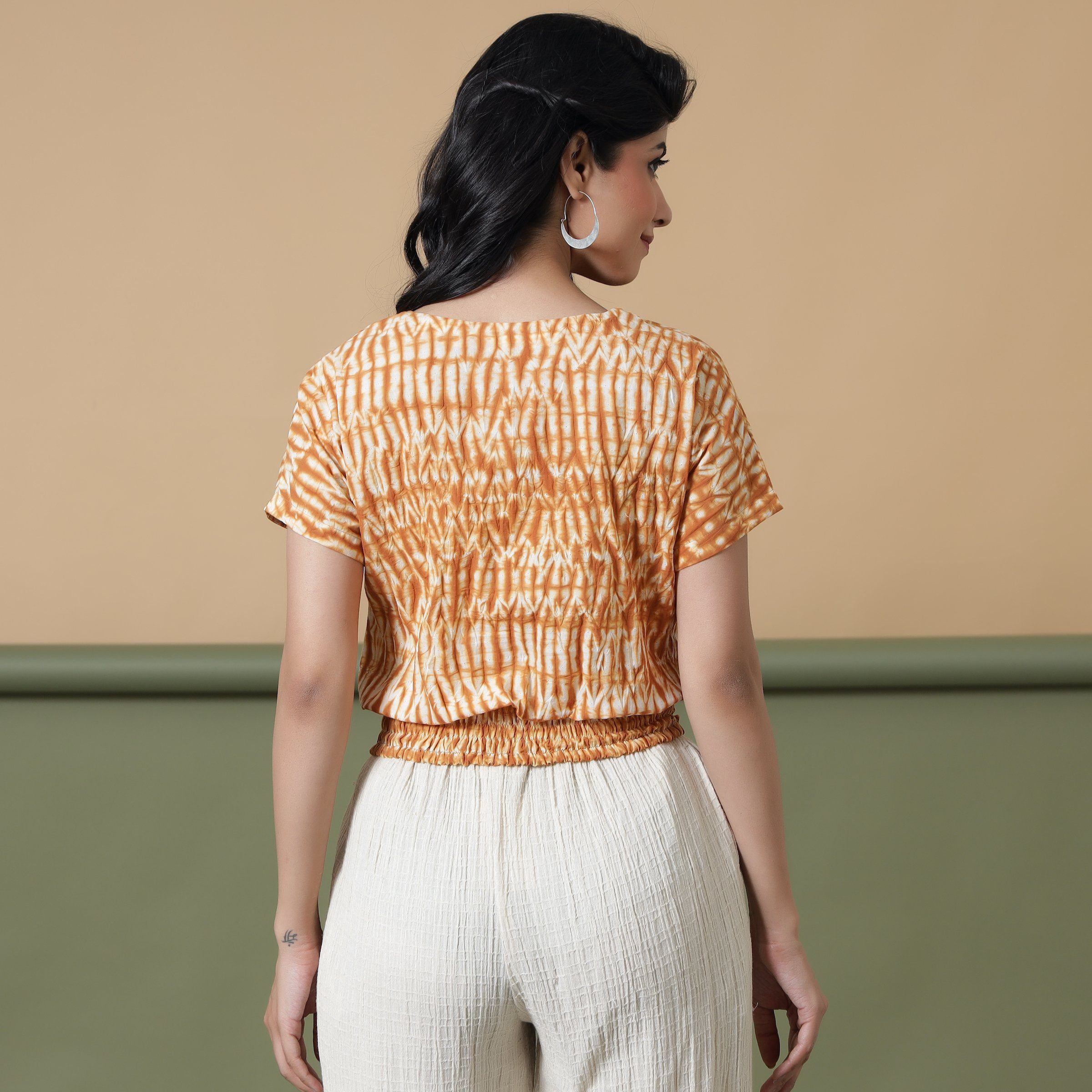 Back View of a Model wearing Shibori Button-Down Blouson Top
