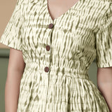 Front Detail of a Model wearing Shibori Button-Down Green Peplum Top