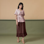 Front View of a Model wearing Shibori Button-Down Maroon Peplum Top