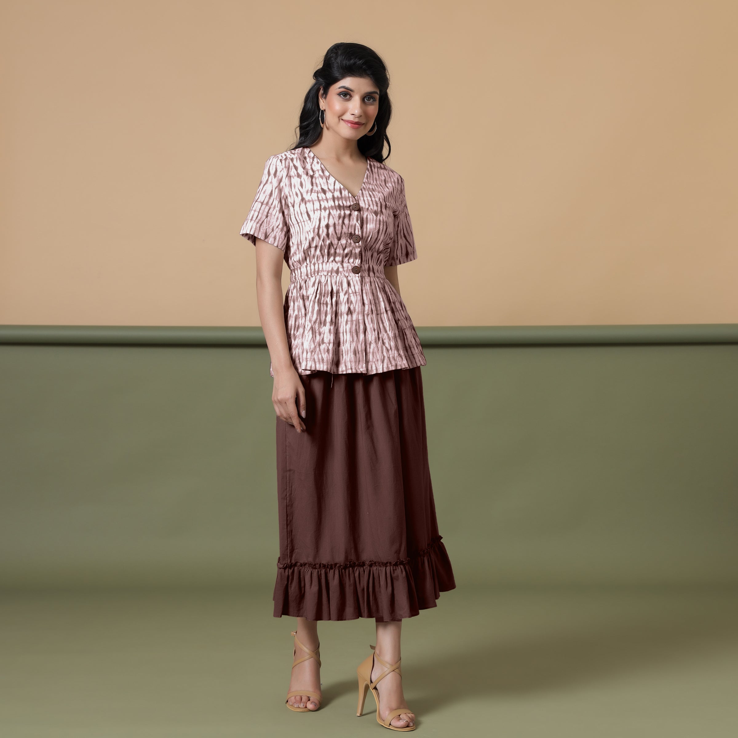 Front View of a Model wearing Shibori Button-Down Maroon Peplum Top