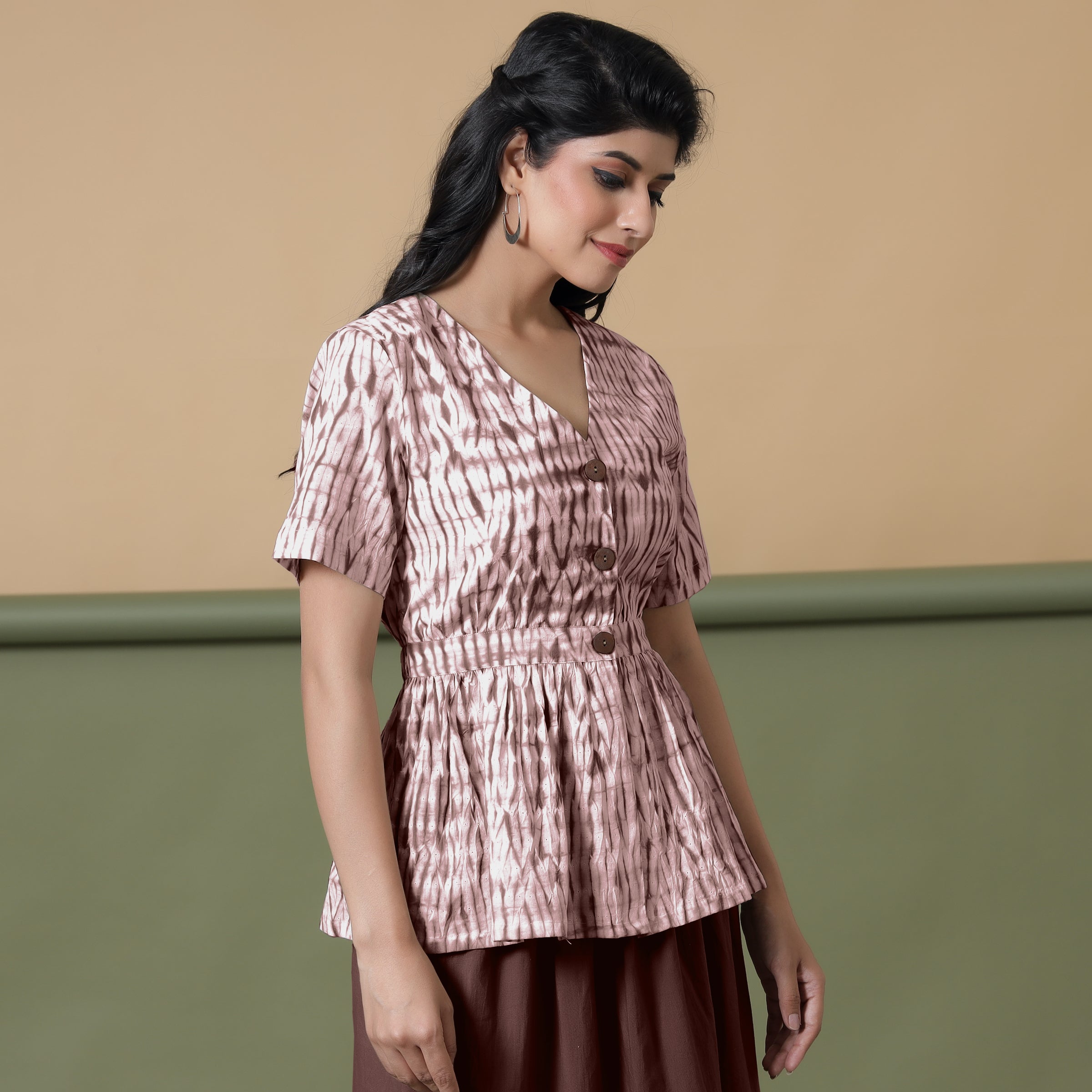 Right View of a Model wearing Shibori Button-Down Maroon Peplum Top