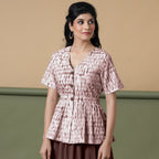Front View of a Model wearing Shibori Button-Down Maroon Peplum Top