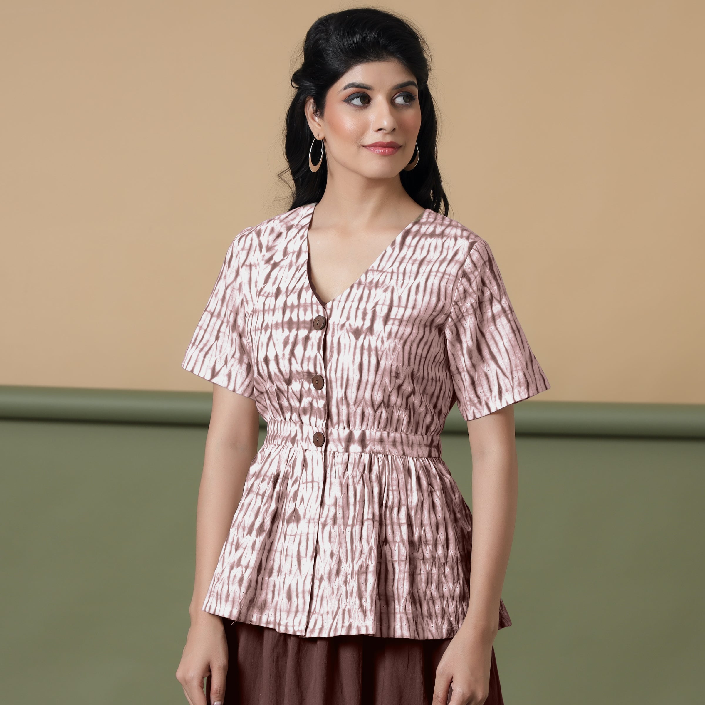 Front View of a Model wearing Shibori Button-Down Maroon Peplum Top