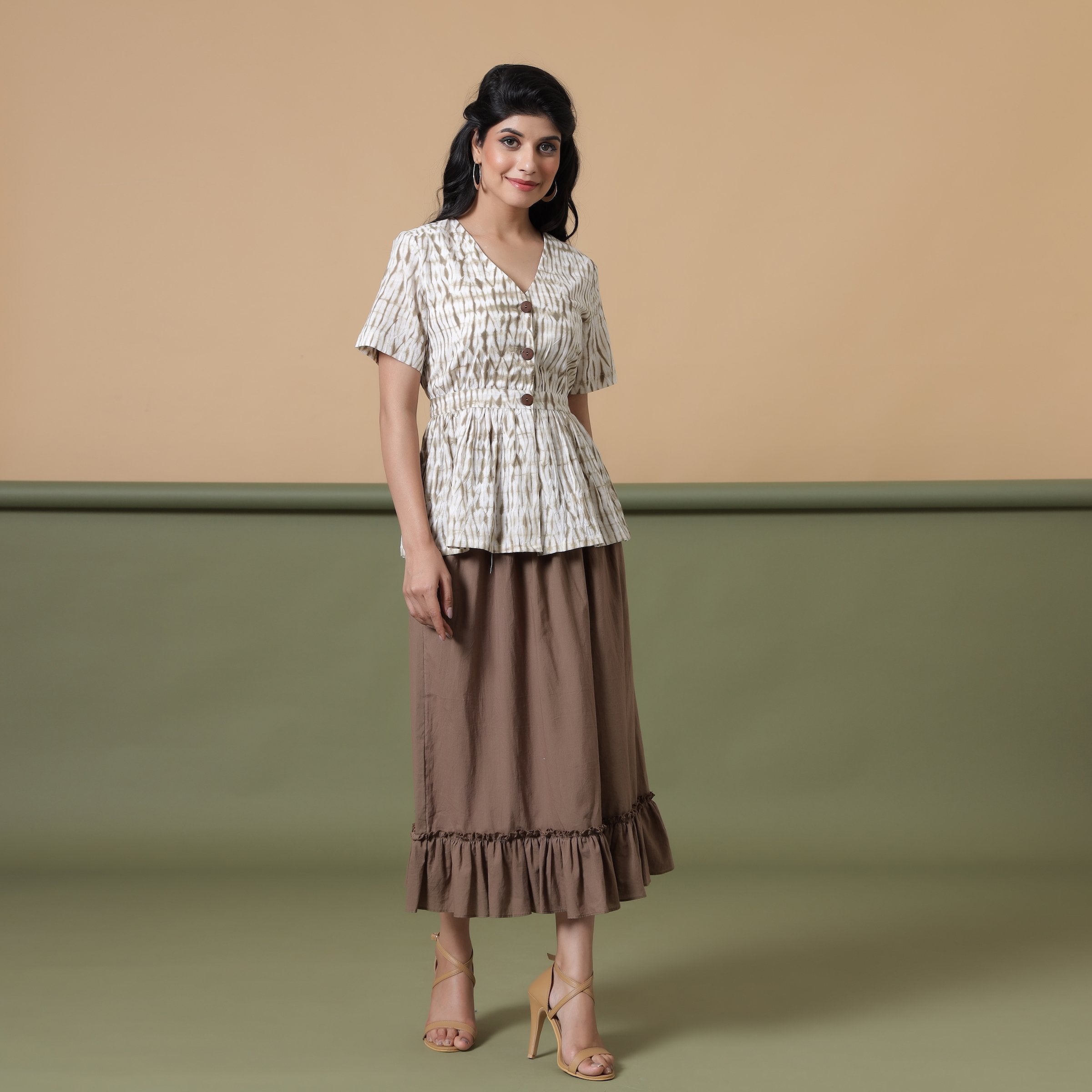 Front View of a Model wearing Shibori Button-Down Peplum Top