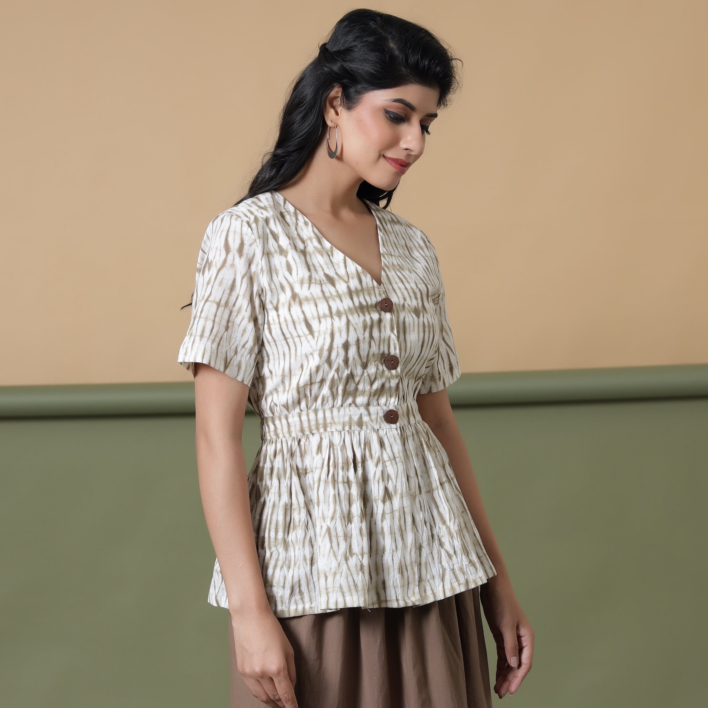 Right View of a Model wearing Shibori Button-Down Peplum Top