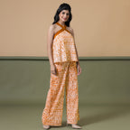 Right View of a Model wearing Shibori Halter Neck Flared Top